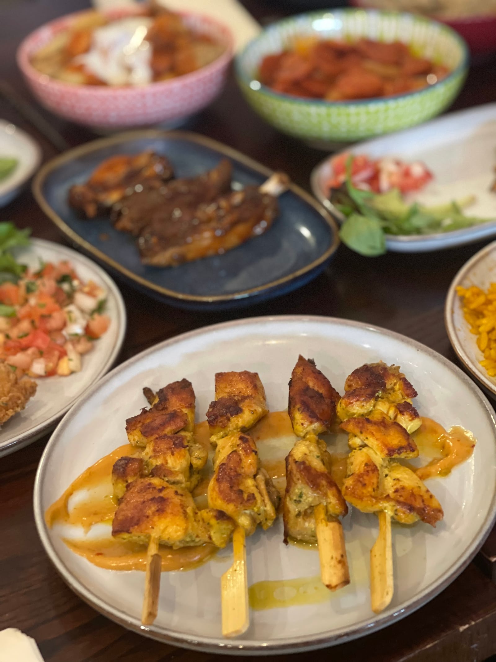 La Fonda chicken skewers surrounded by small plates